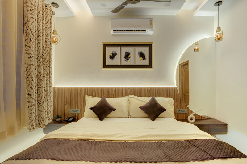Deluxe Comfort Room at dusk with warm ambient lighting and king bed — Sharnam on the Ganges, Rishikesh