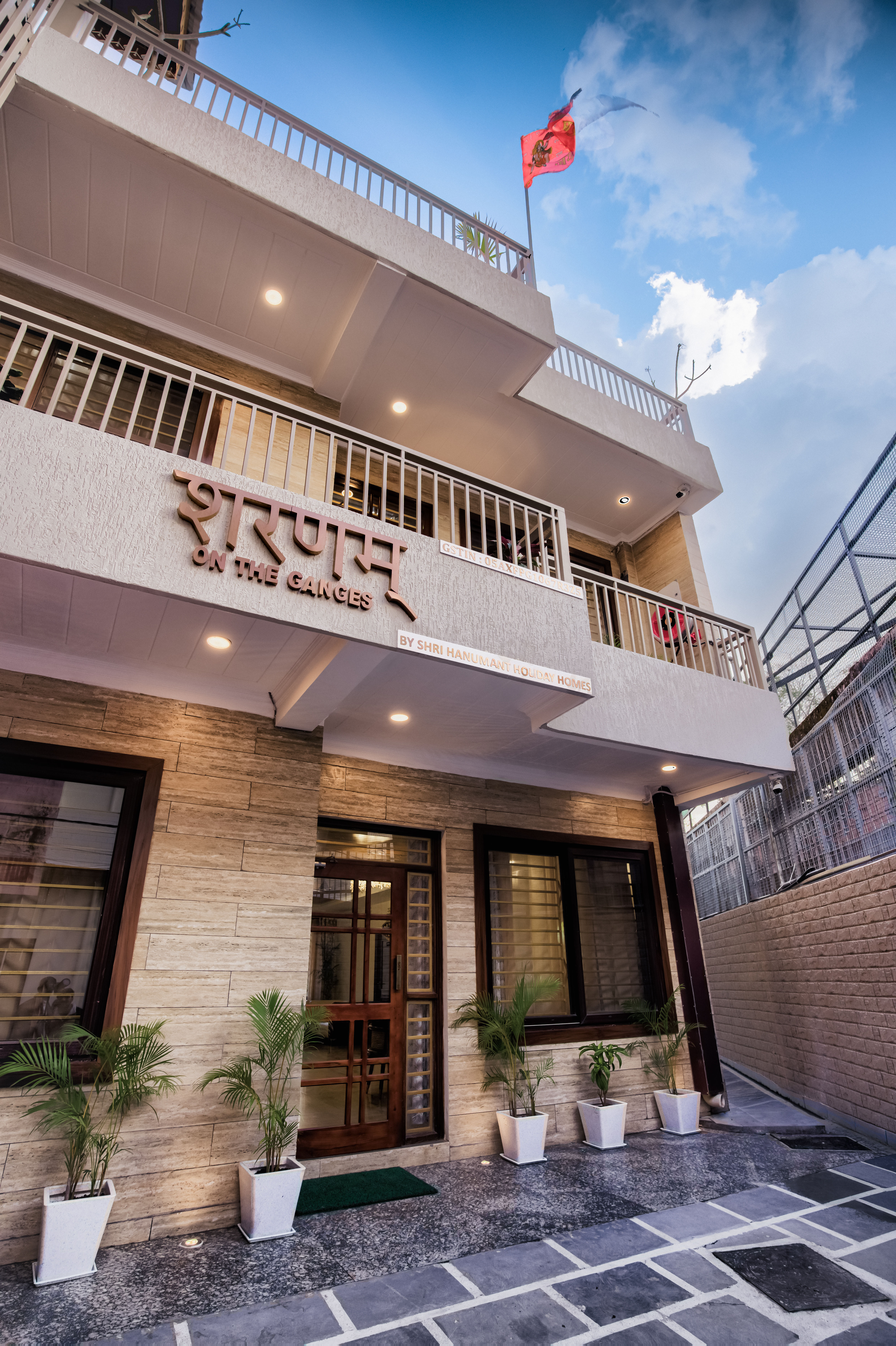 Front exterior facade of the hotel building with landscaped approach — Sharnam on the Ganges, Rishikesh