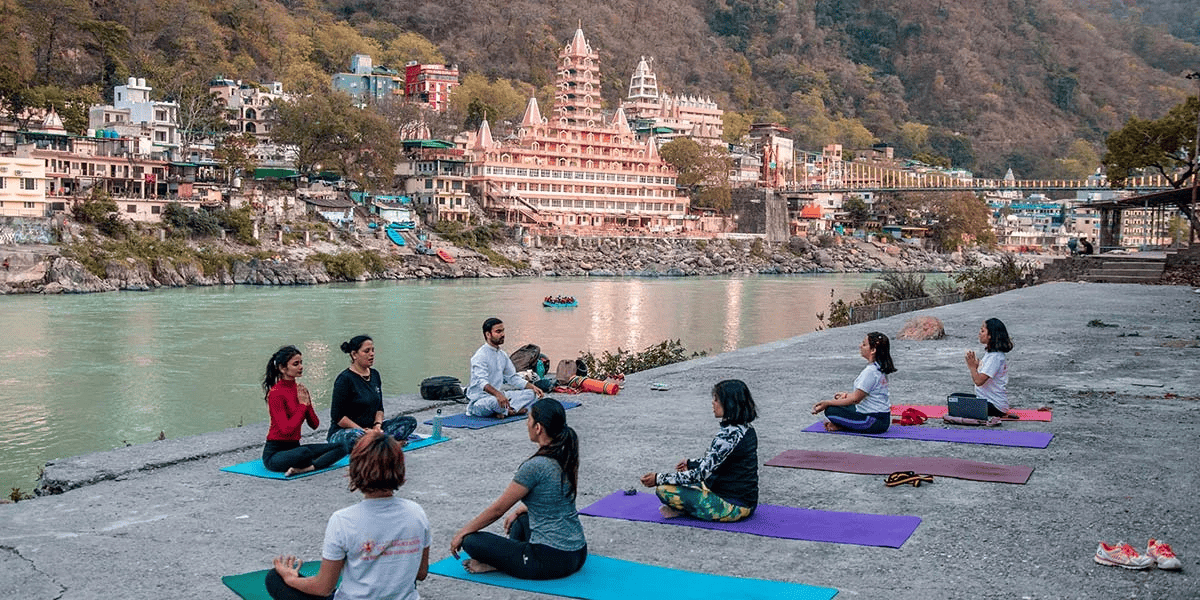 Outdoor group yoga session at sunrise in Rishikesh — wellness experiences near Sharnam on the Ganges