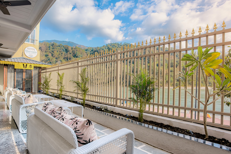 Private balcony with outdoor seating and wide Ganges river view — Sharnam on the Ganges, Rishikesh