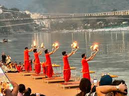 Ganga Aarti ceremony at dusk with oil lamps and devotees on the Rishikesh river ghat — Sharnam on the Ganges