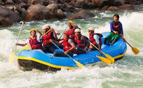 White-water river rafting on the Ganges with forested hillside backdrop — adventure experiences near Sharnam on the Ganges, Rishikesh
